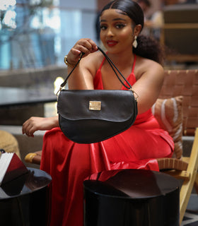 Denri Africa's black Montana Sling Bag. Black minimalist sling purse, smooth vegan leather.