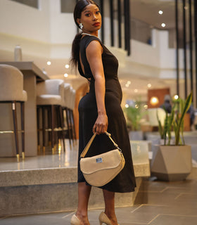Denri Africa's beige Montana Sling Bag. Classic minimalist beige sling, portable and chic, everyday go-to bag.