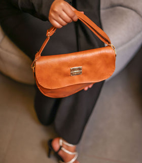 Denri Africa's spice Montana Sling Bag. Beautiful spice brown sling bag, modern vegan leather design.