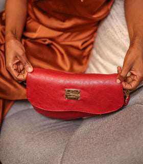 Denri Africa's red Montana Sling Bag. Sleek vegan leather sling bag, bold red color, perfect for active days.