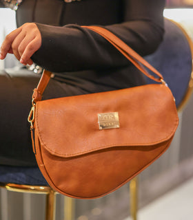Denri Africa's spice Montana Sling Bag. Rich earthy-tone sling, vegan leather, stylish crossbody.