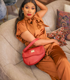 Denri Africa's red Montana Sling Bag. Functional red crossbody sling, minimalist design, travel and daily use.