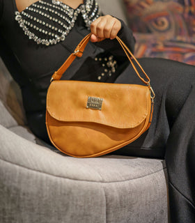 Denri Africa's beige Montana Sling Bag. Soft-tone crossbody bag, lightweight vegan leather sling, stylish daily carry.