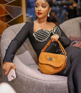Denri Africa's beige Montana Sling Bag. Soft beige sling purse, minimal look, ideal for daily movement.