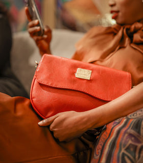 Denri Africa's red Montana Sling Bag. Eye-catching red sling purse, compact design, convenient daily carry.