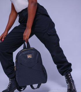 Denri Africa's black Monah Backpack. Classic black everyday backpack, water‑resistant, roomy storage for books and essentials.