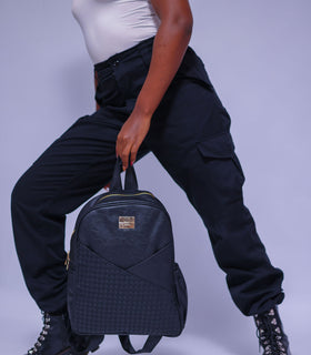Denri Africa's black Monah Backpack. Minimalist black backpack, padded laptop section, perfect for work or travel.